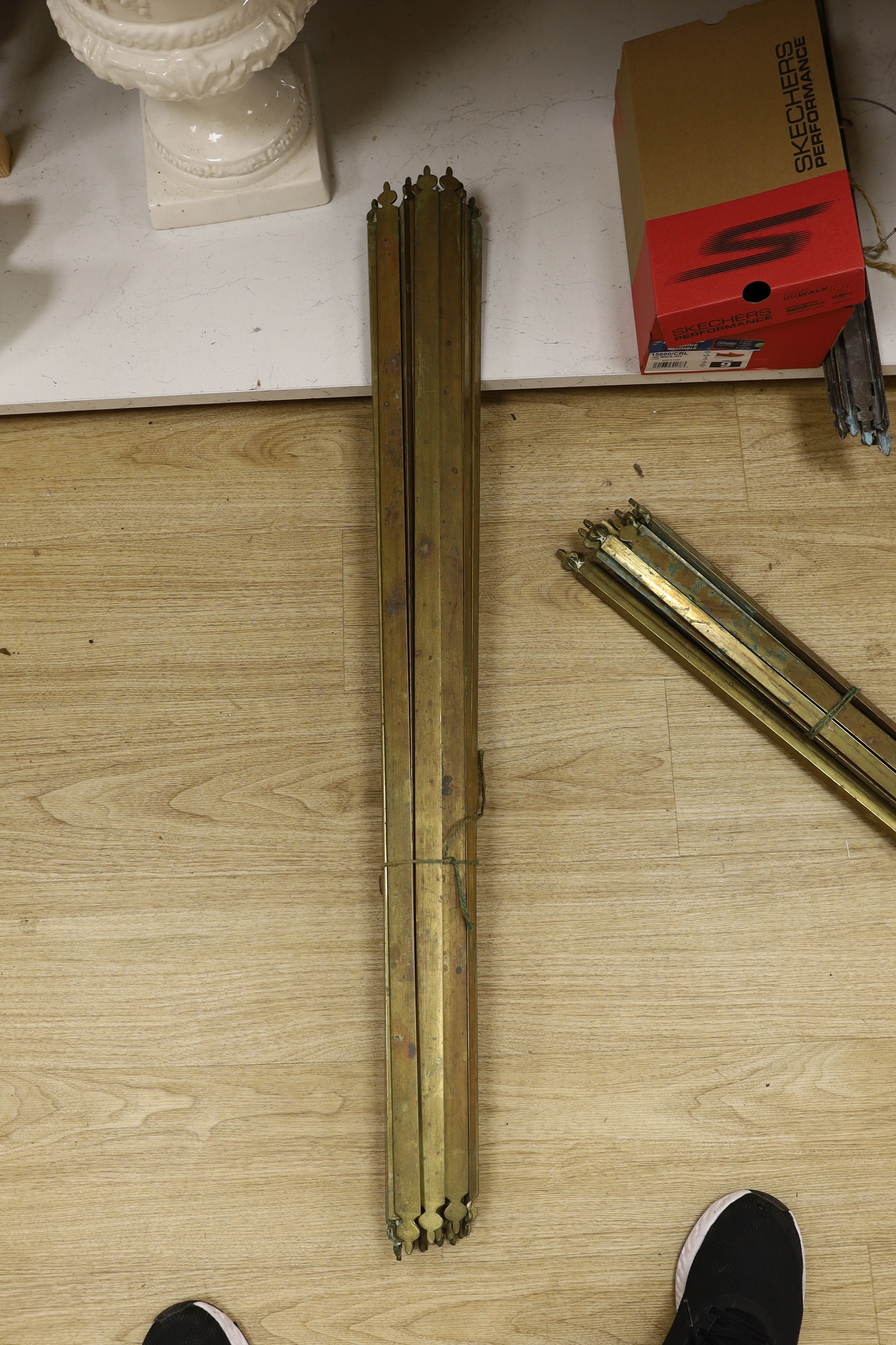 Two sets of brass stair rods with fittings.